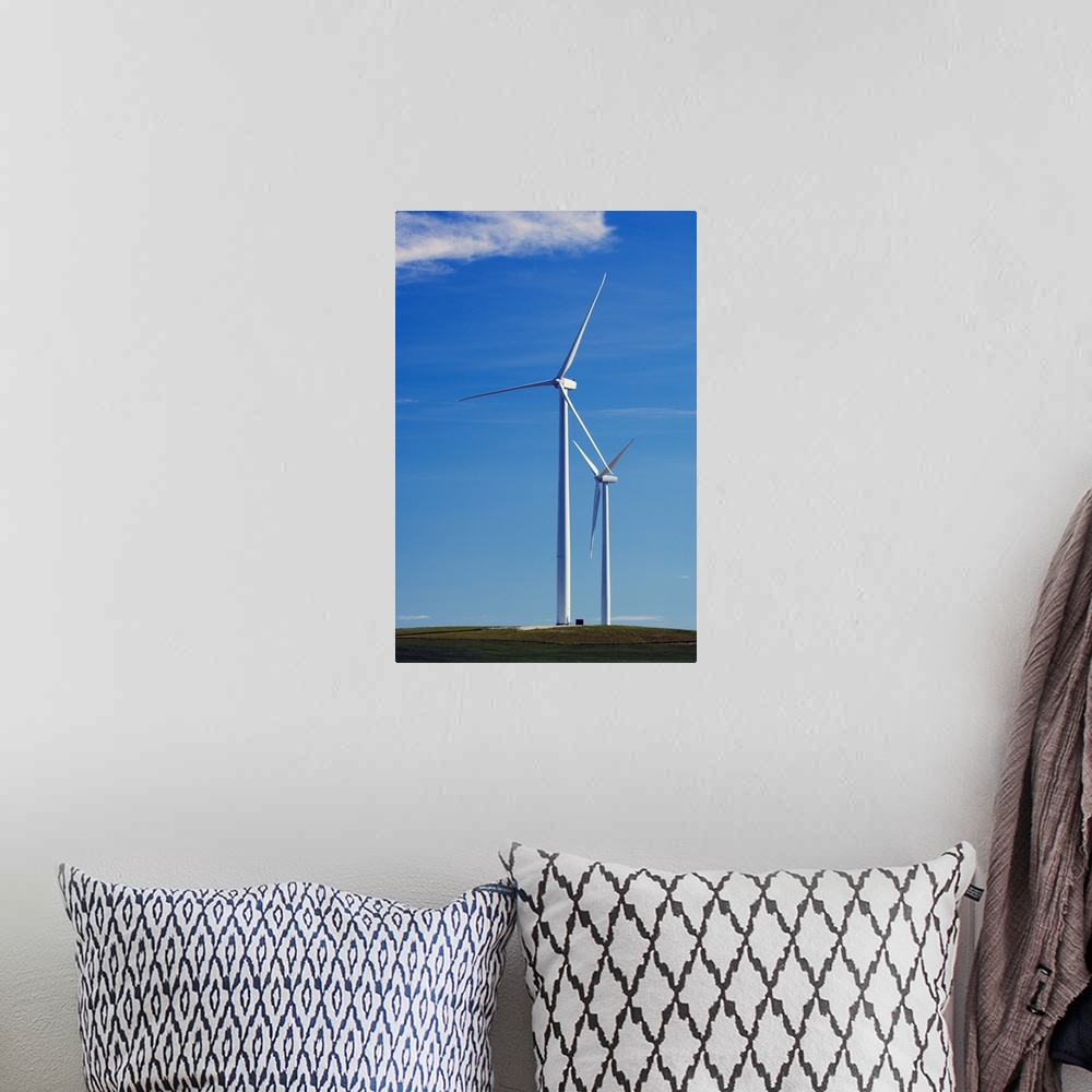 A bohemian room featuring Pair of wind farm turbines in green grass, blue sky, Montana