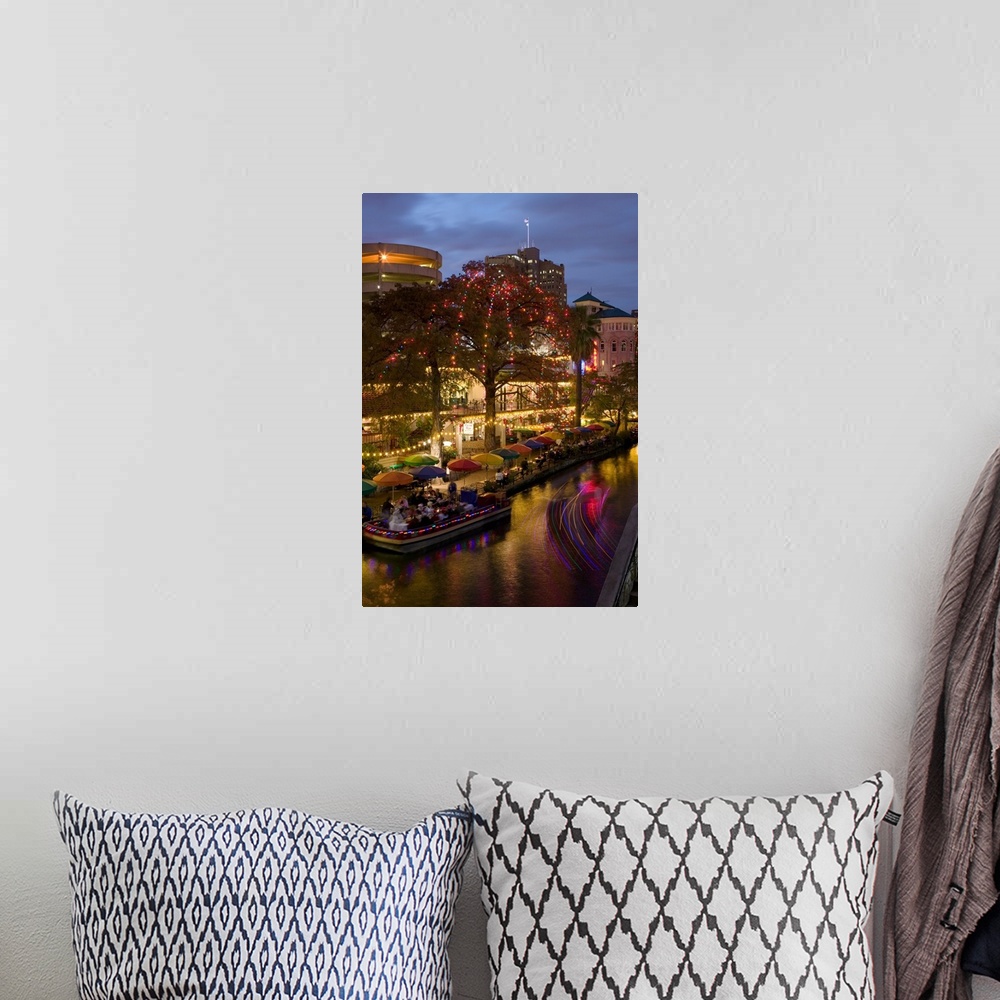 A bohemian room featuring Vertical photo on canvas of people eating at an outdoor restaurant next to a river underneath umb...