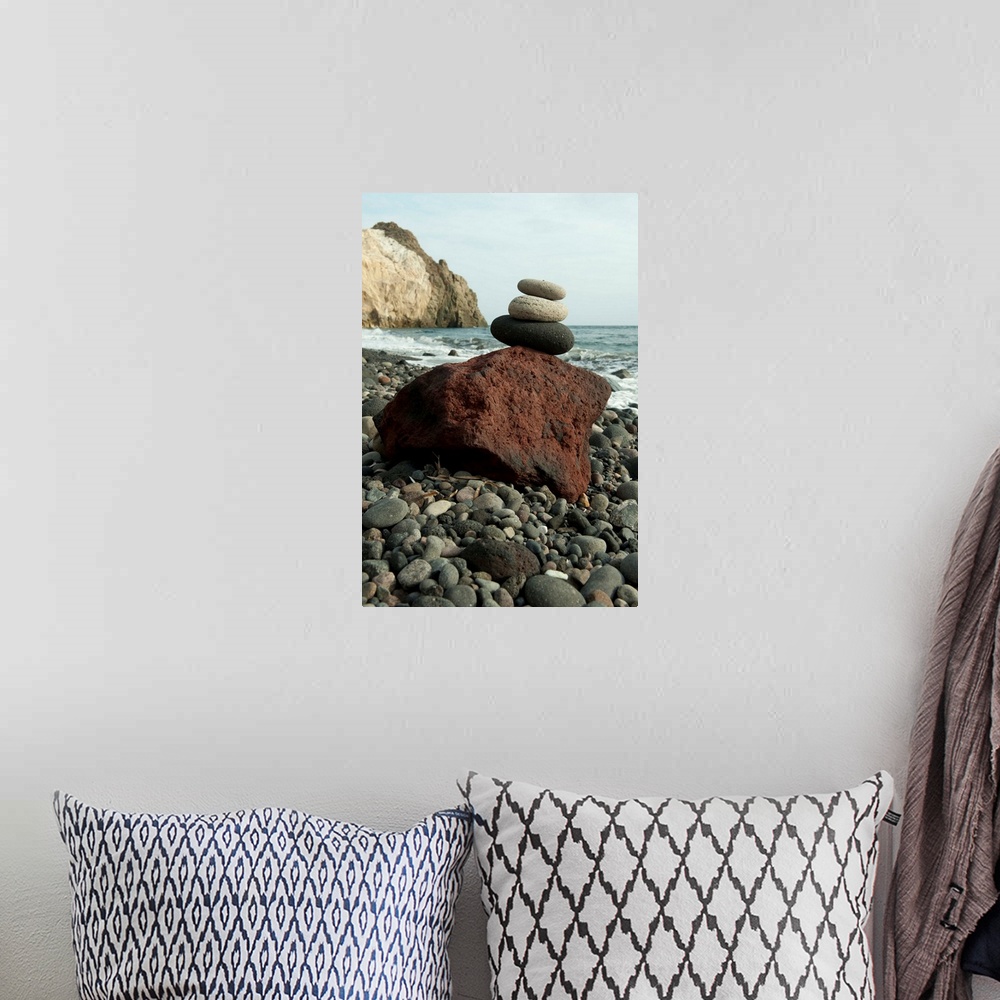 A bohemian room featuring Stone balancing on a rock at the coast, Akrotiri, Santorini, Cyclades Islands, Greece