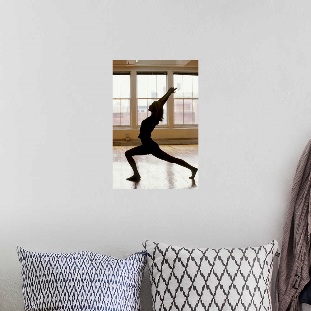 A bohemian room featuring Young woman in yoga position