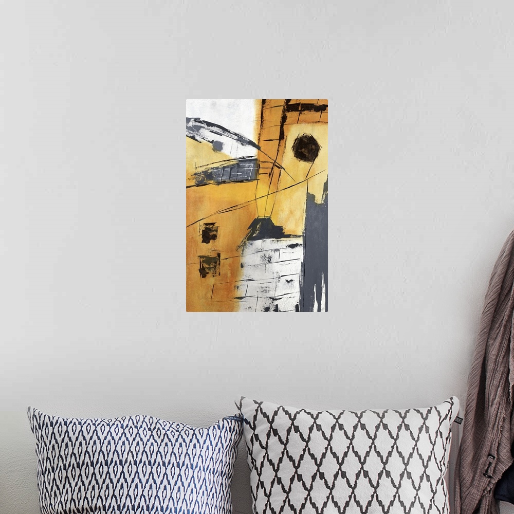 A bohemian room featuring Abstract painting in colors of yellow, gray and orange.