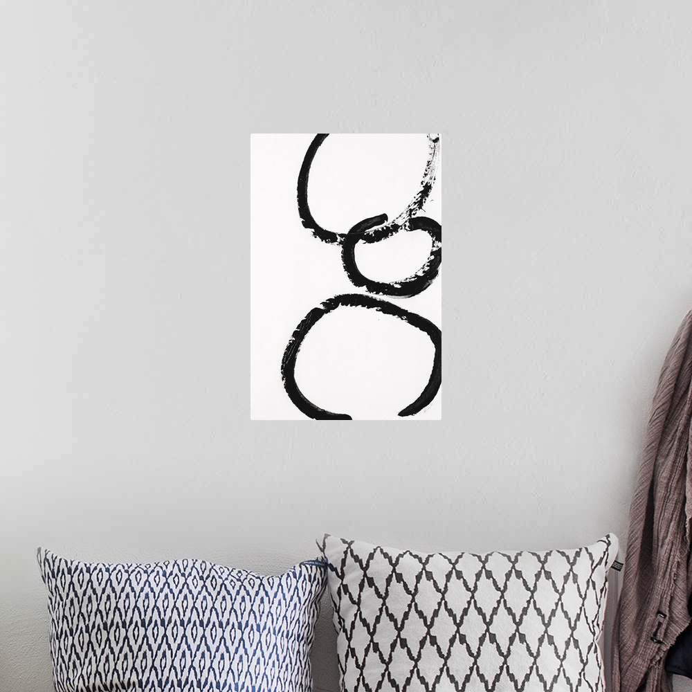 A bohemian room featuring Three black circles stacked on top of each other on a white background.