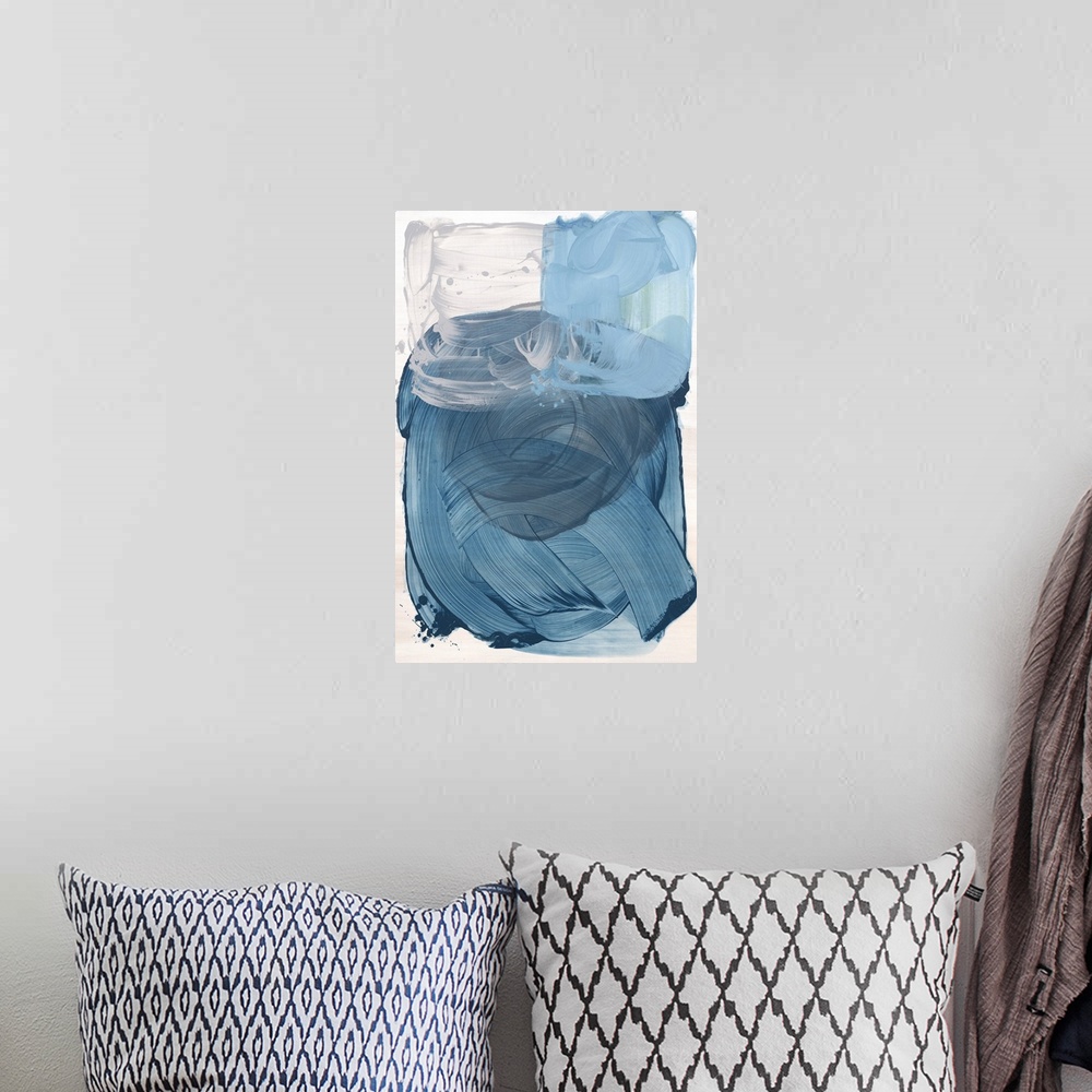 A bohemian room featuring Blue abstract artwork in a series of three primary color paintings.