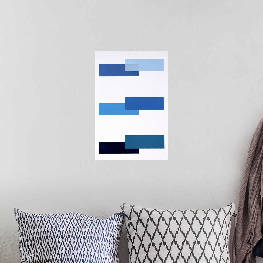 A bohemian room featuring Geometric abstract painting with a solid white background and various shades of blue rectangles p...