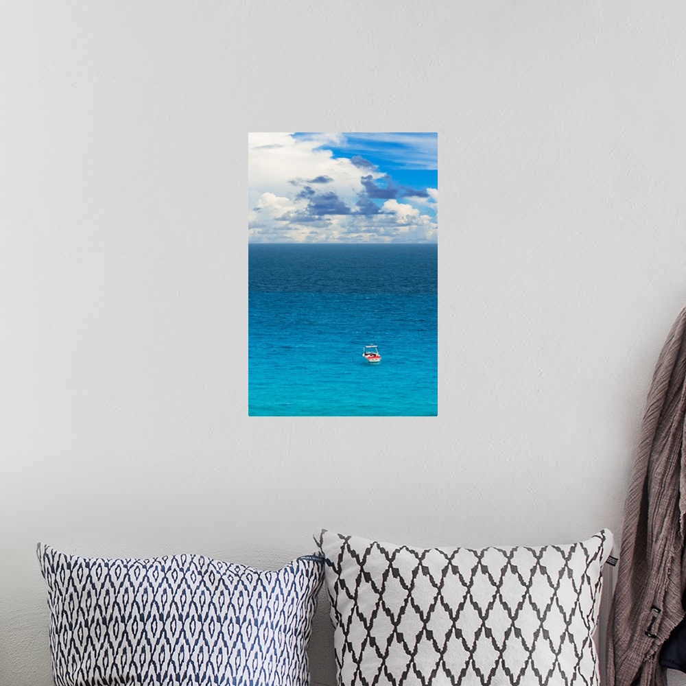 A bohemian room featuring Photograph of a single boat on the clear blue sea. From the Viva Mexico Collection.