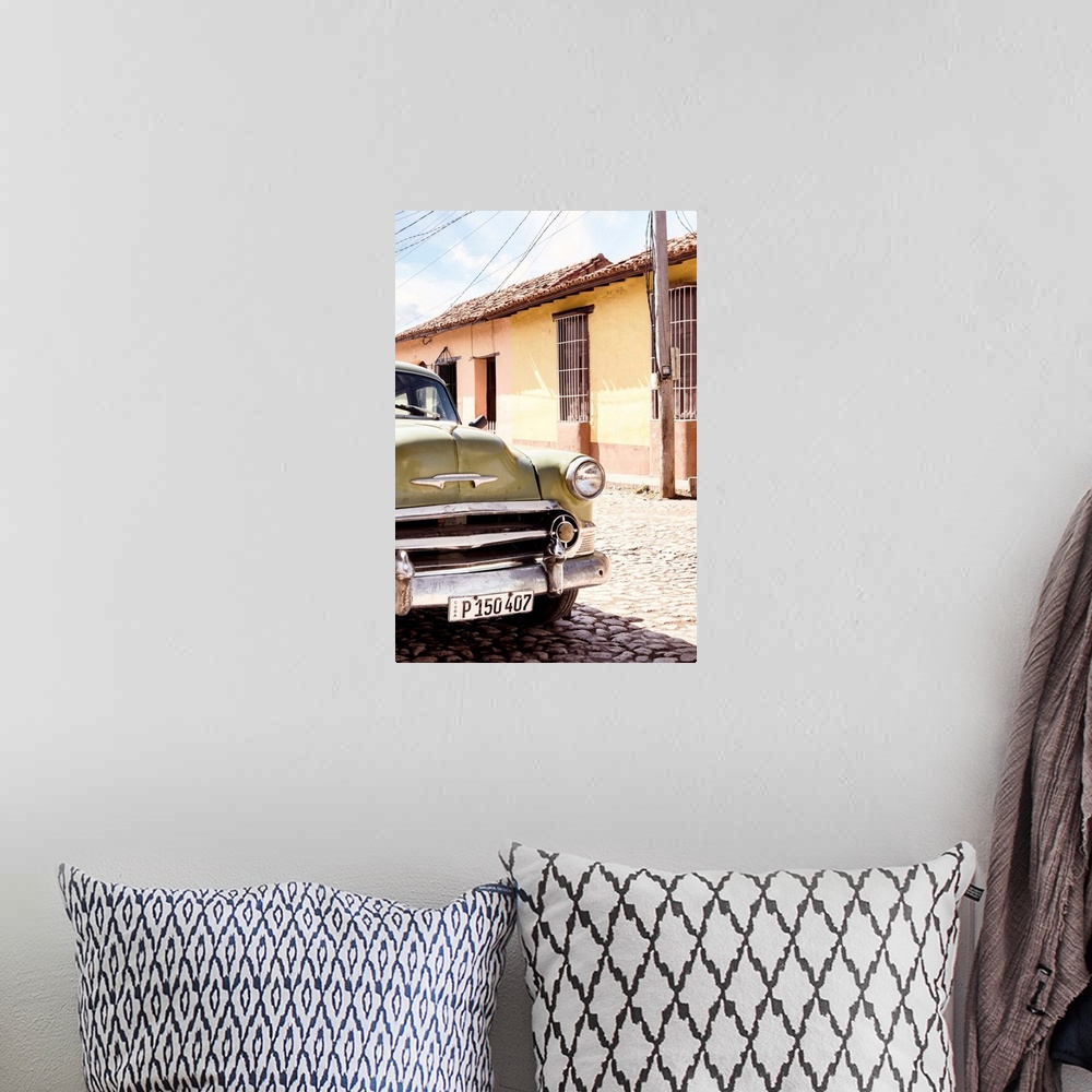 A bohemian room featuring Photograph of the front side of an old Chevy in the streets of Havana.