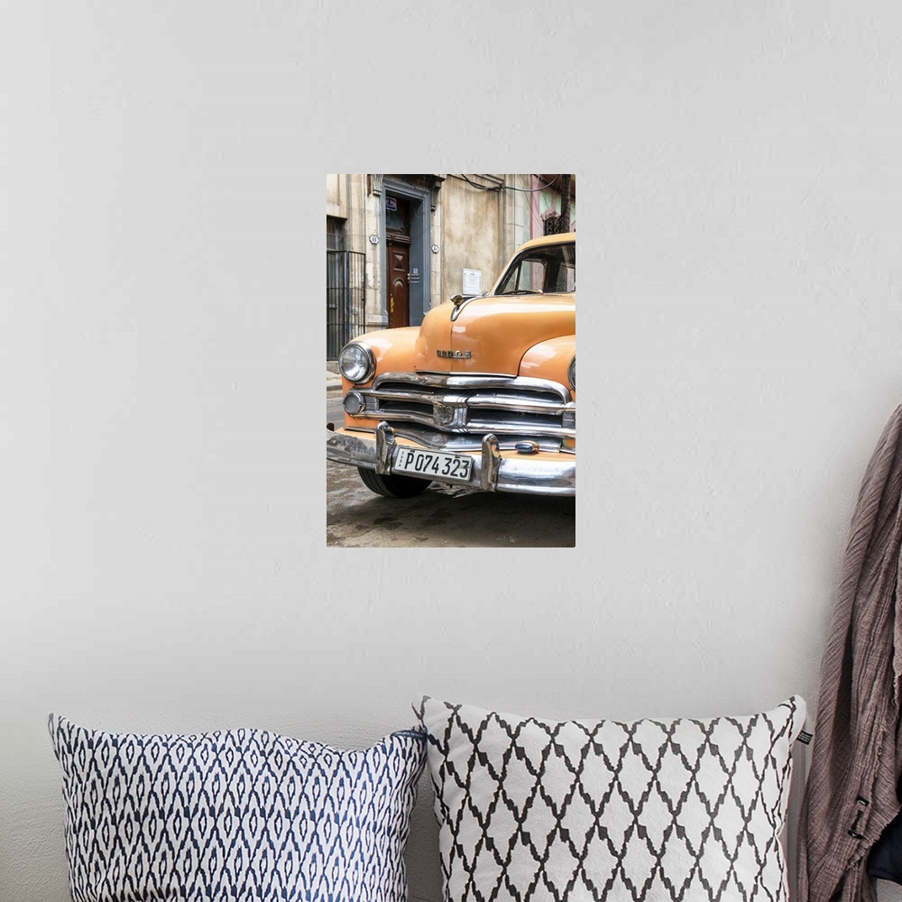 A bohemian room featuring Photograph of the front of an orange vintage Dodge car parked in downtown Havana.