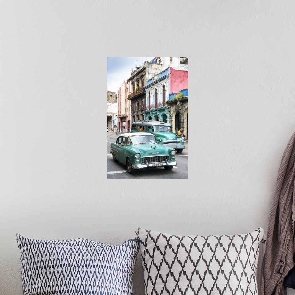 A bohemian room featuring Photograph of two green vintage Chevrolets in a Havana street scene.