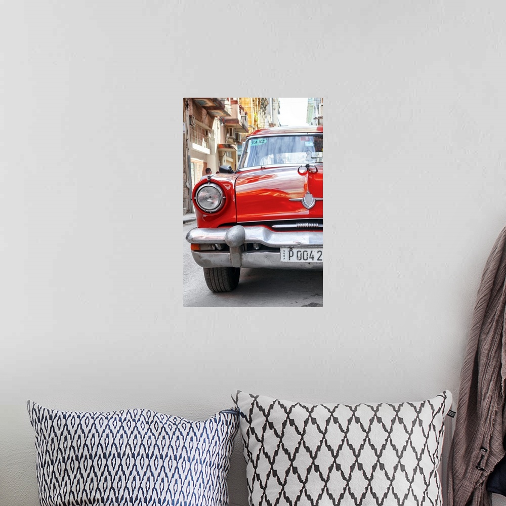 A bohemian room featuring Photograph of the front of a bright red taxi cab in Havana.