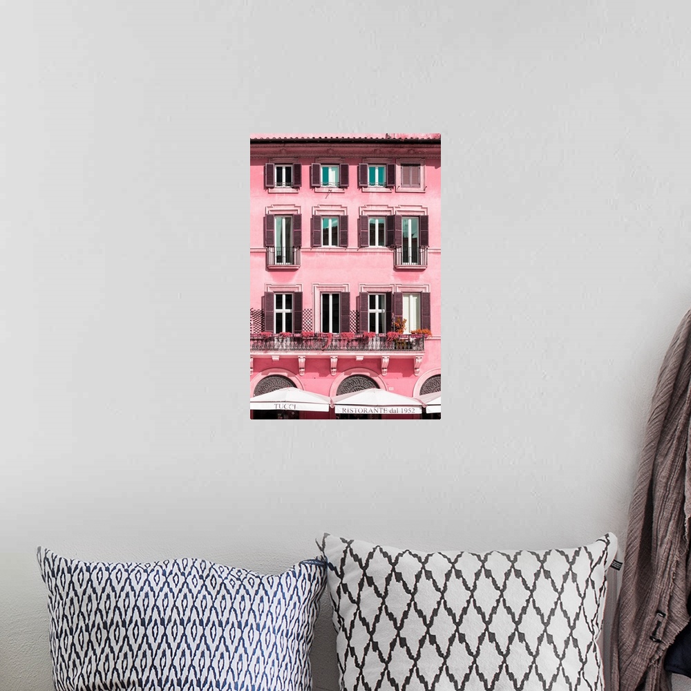 A bohemian room featuring It's a pink facade of a building in the city of Rome in Italy.