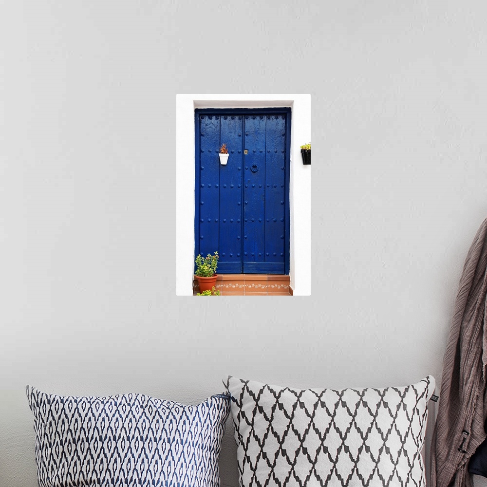 A bohemian room featuring It's an old blue marine door in Mijas, Spain.