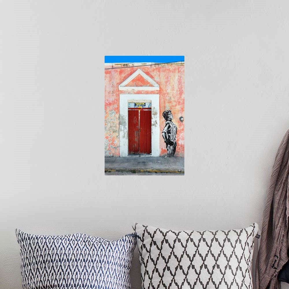 A bohemian room featuring Photograph of the exterior of a building with a red door and graffiti of a woman spray painted on...