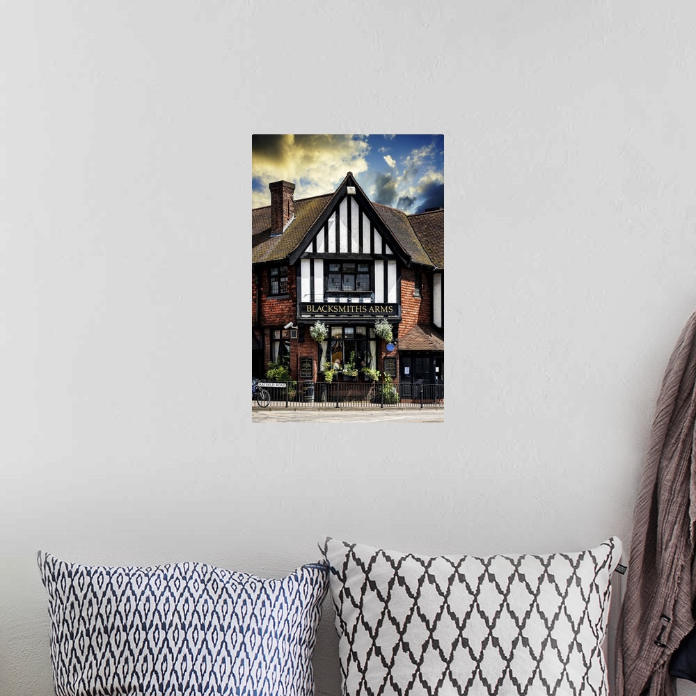 A bohemian room featuring Fine art photo of a quaint inn in the United Kingdom, an example of classic English architecture.