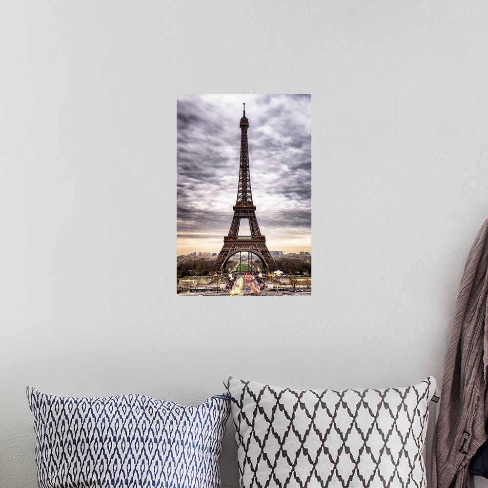 A bohemian room featuring Stunning photograph of the iconic Eiffel Tower in Paris with cloudy skies.