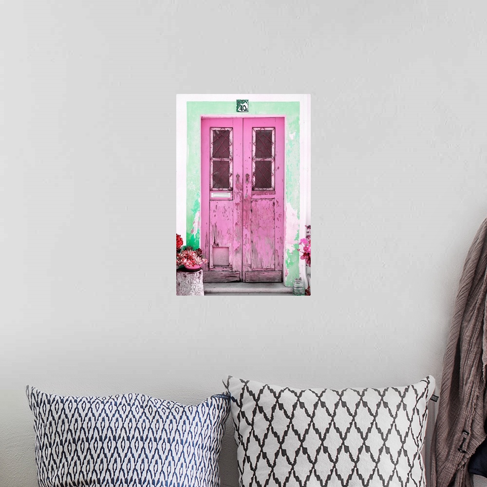 A bohemian room featuring It's an old pink door entrance to a traditional house in Portugal.