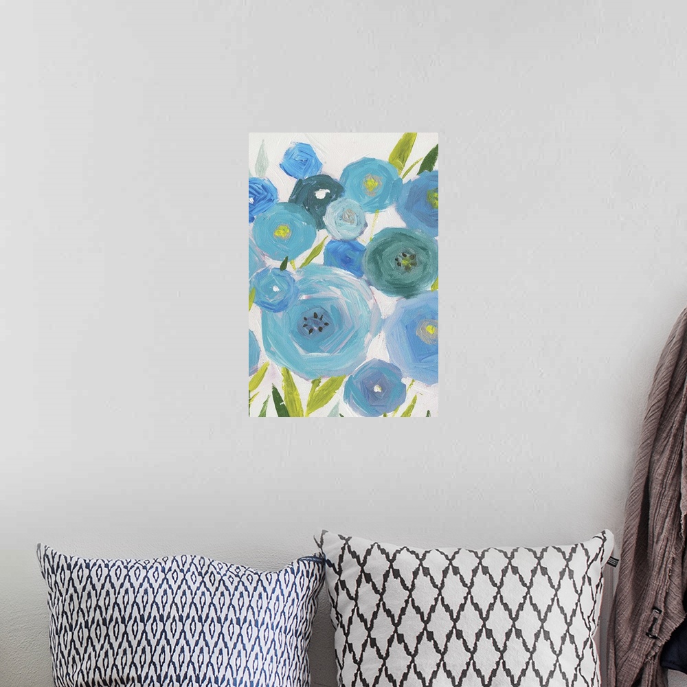 A bohemian room featuring A vertical painting of different shades of blue poppies against a neutral backdrop.