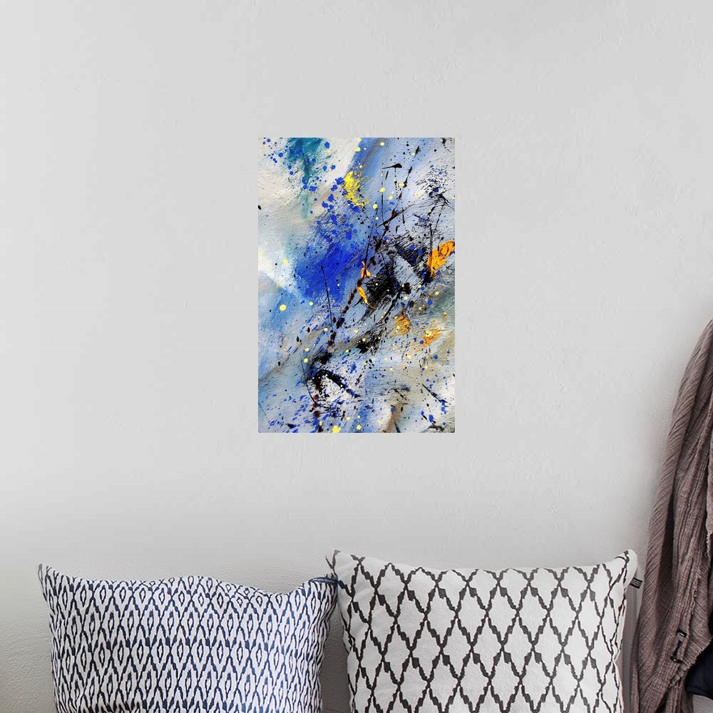 A bohemian room featuring Vertical abstract painting in shades of orange, yellow, blue, and black mixed in with speckled pa...