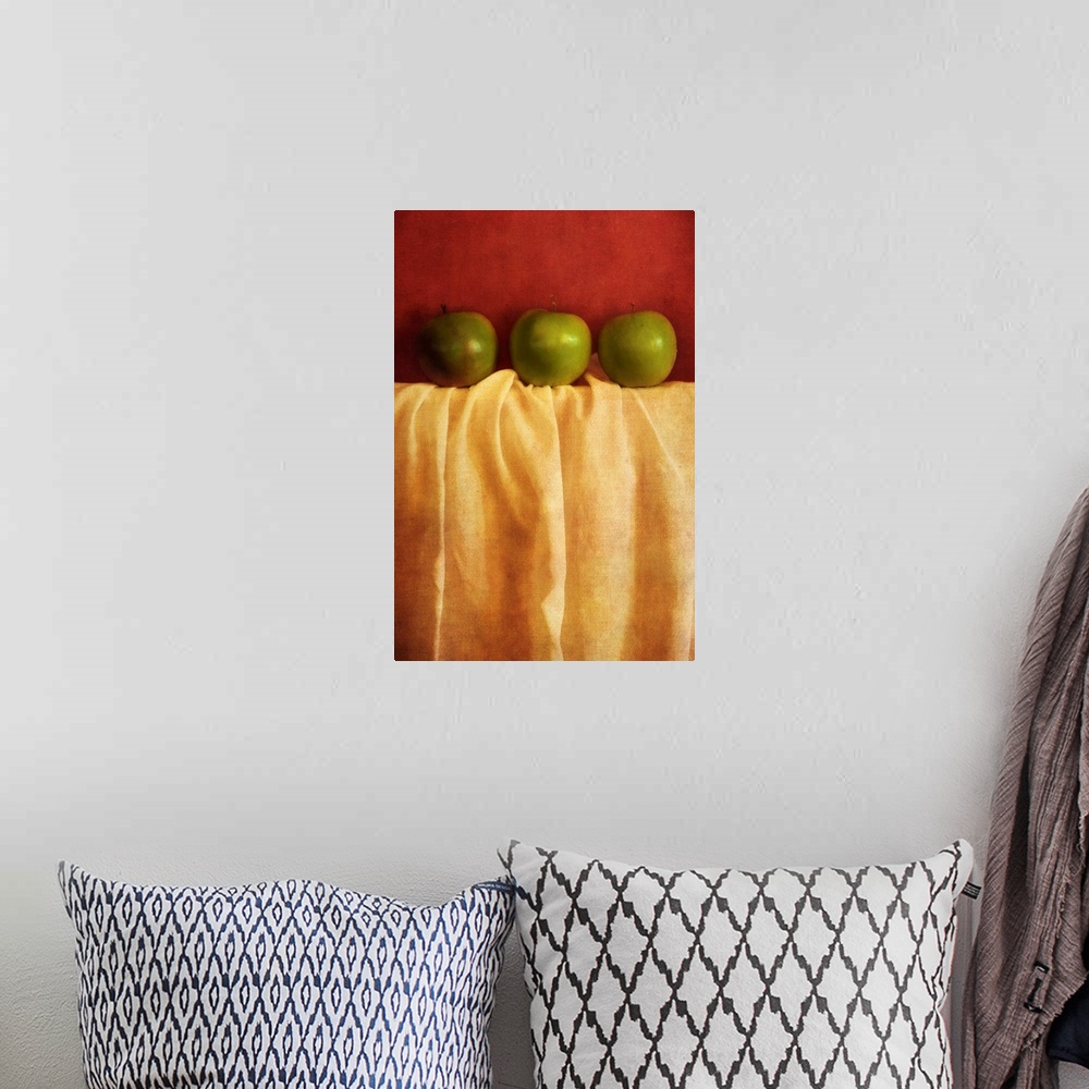 A bohemian room featuring Still life with three granny smith apples against red background