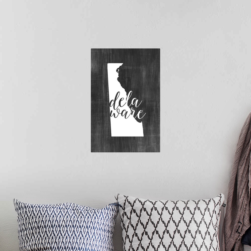 A bohemian room featuring Delaware state outline typography artwork.