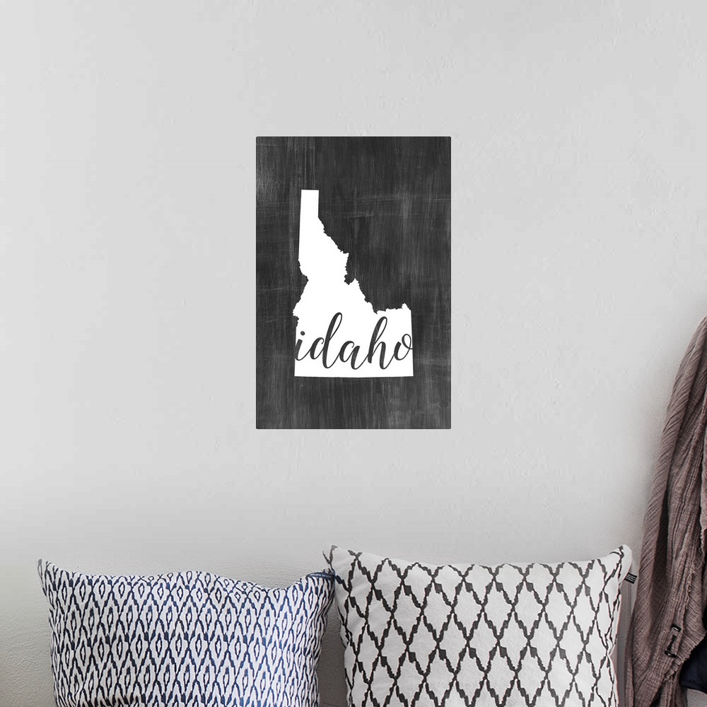 A bohemian room featuring Idaho state outline typography artwork.