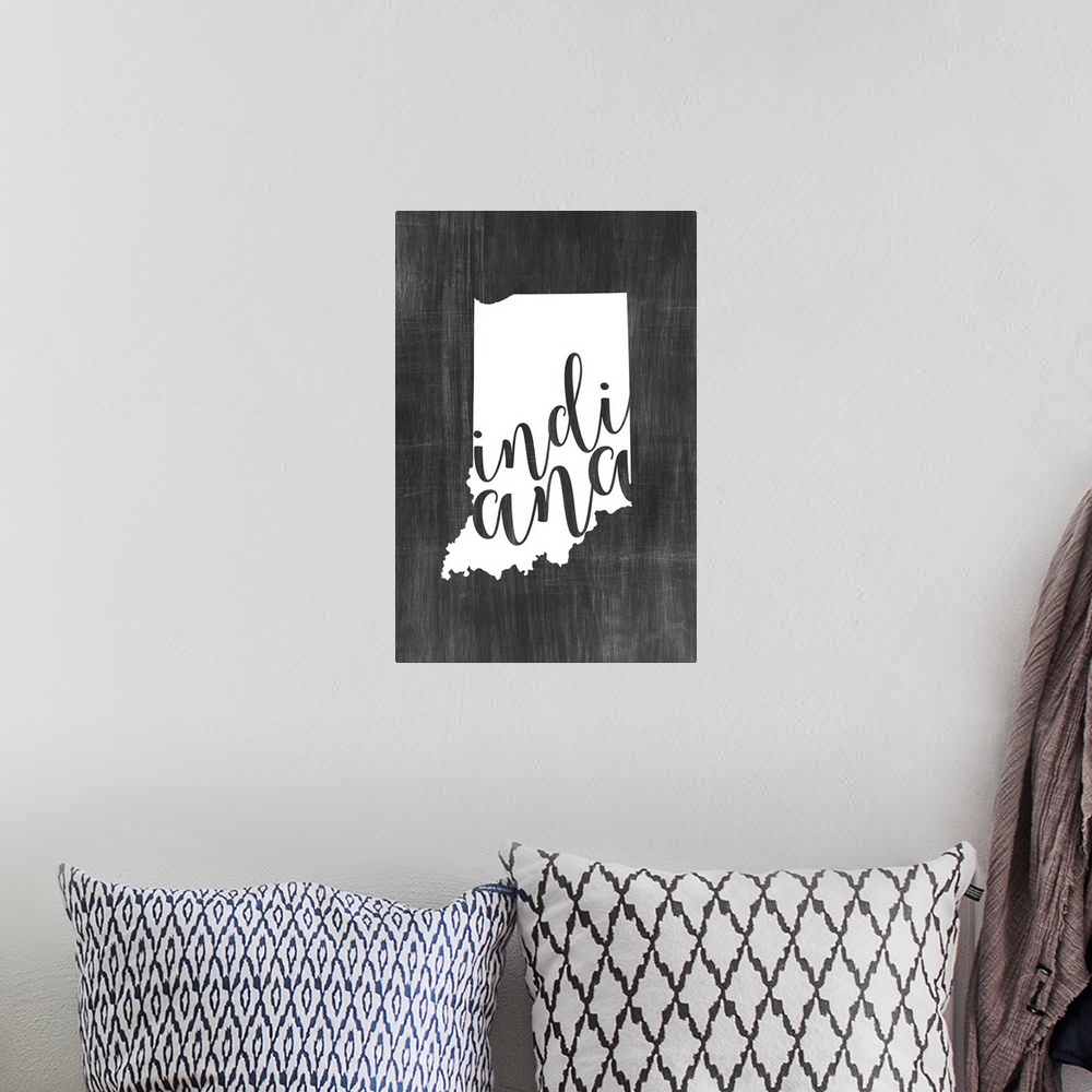 A bohemian room featuring Indiana state outline typography artwork.