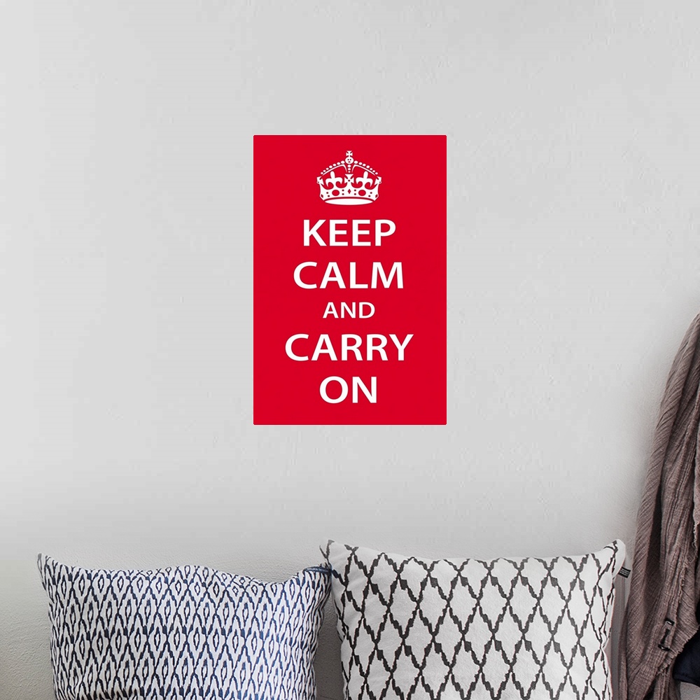 A bohemian room featuring A large vertical print with a red background and the text "Keep Calm and Carry On" in bold white ...