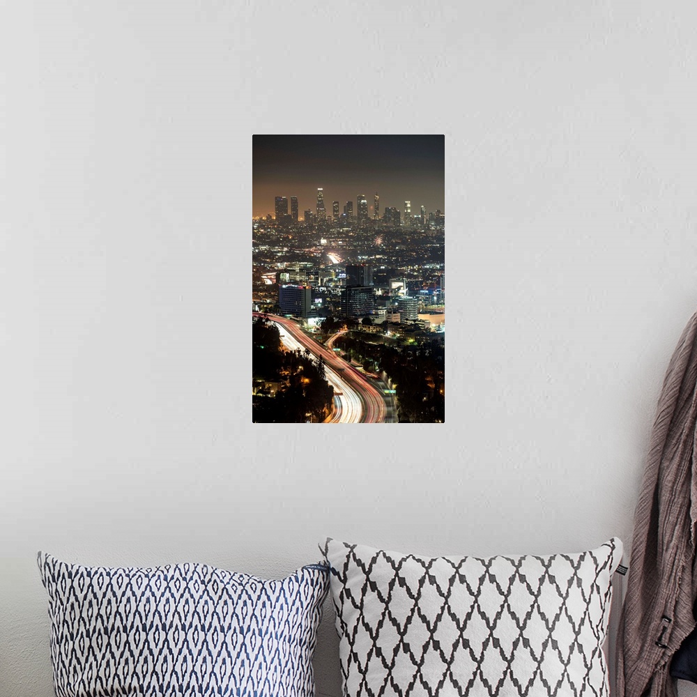 A bohemian room featuring Aerial view photograph of Los Angeles, California with a hazy skyline at night.