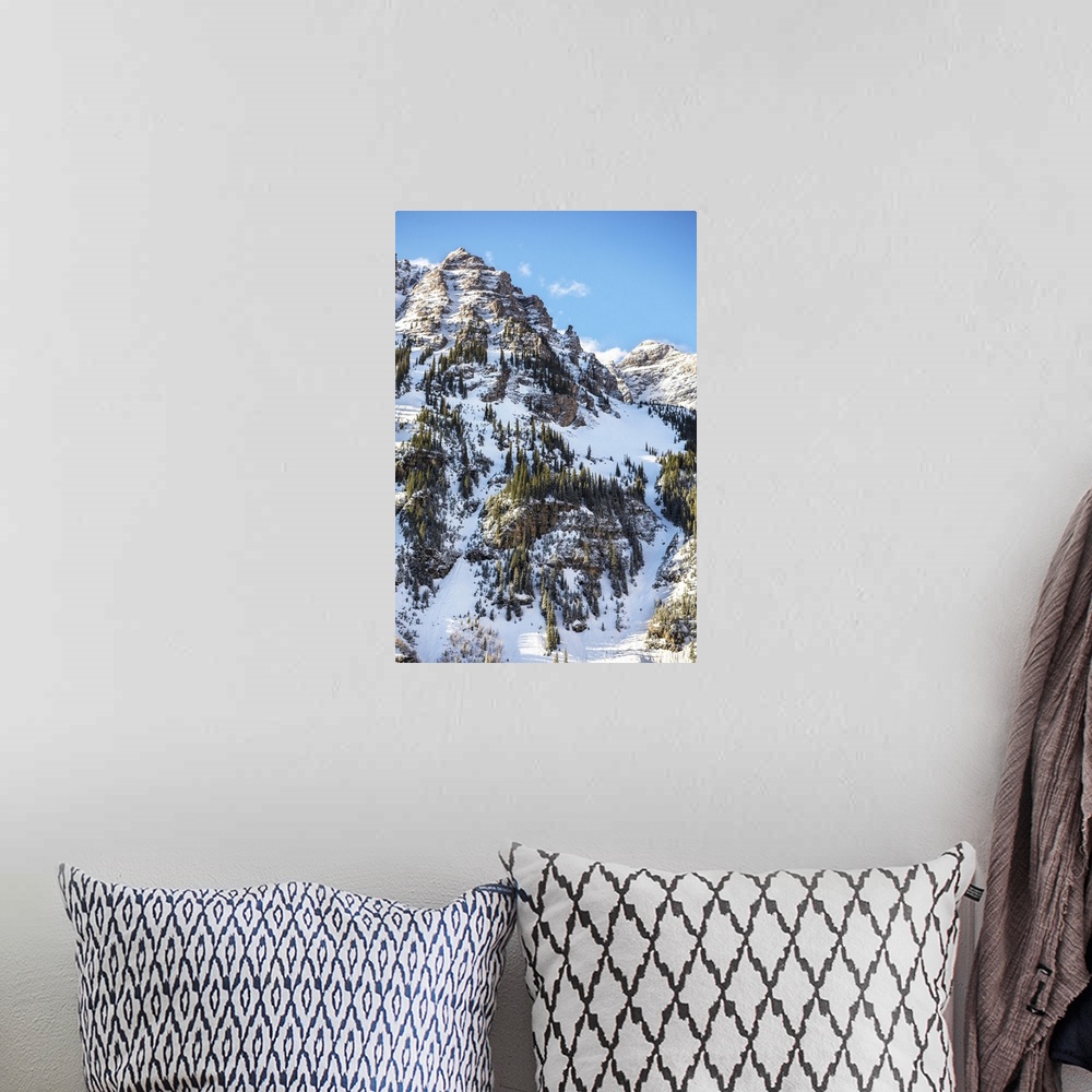 A bohemian room featuring Snow and pine trees on the mountainside under a blue sky, Maroon Bells, Colorado.
