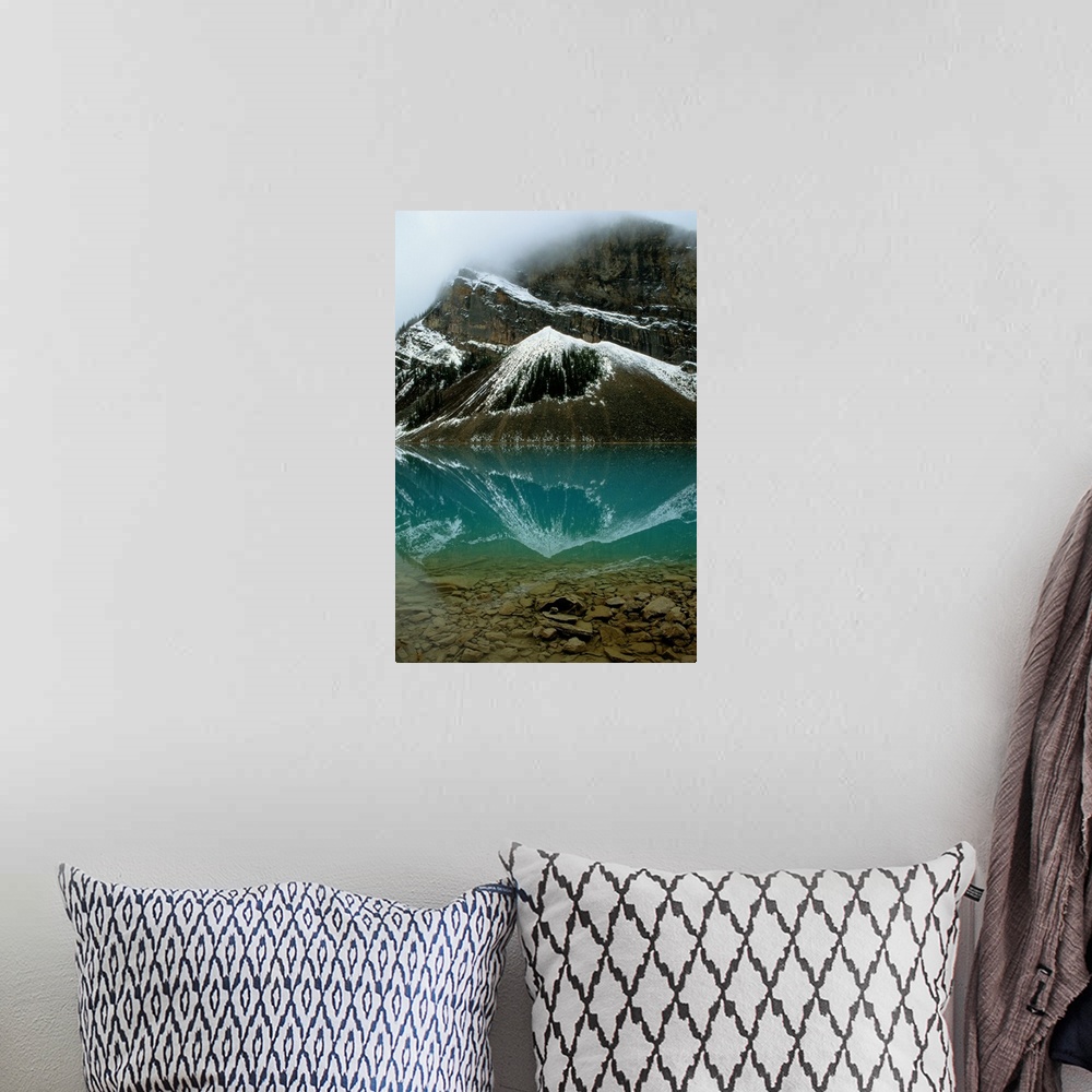A bohemian room featuring Fog has lifted from Lake Louise and reflections of the snow-capped mountains ar e visible in this...