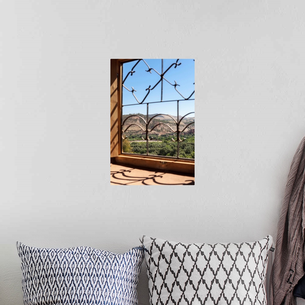 A bohemian room featuring A view of the Ourika Valley as glimpsed through the window of a traditional Berber house, Morocco...
