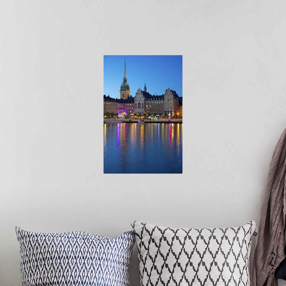 A bohemian room featuring Gamla Stan and Riddarholmen with spire of Riddarholmskyrkan at dusk, Stockholm, Sweden