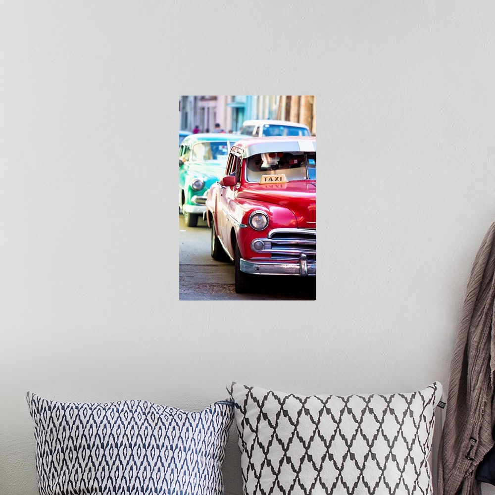 A bohemian room featuring Vintage American cars used as local taxis, driving down Avenue Colon during afternoon rush hour, ...