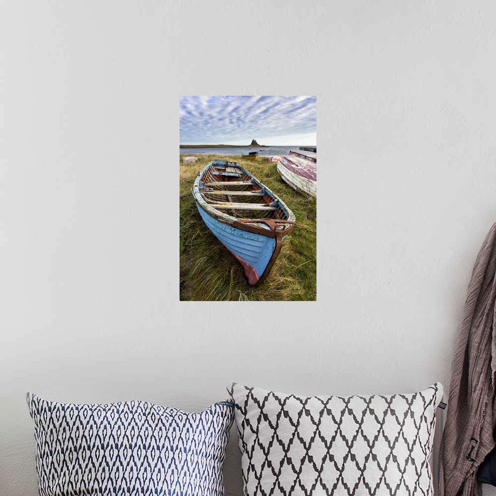 A bohemian room featuring View towards Lindisfarne Castle with an old blue and red fishing boat in the foreground, Lindisfa...