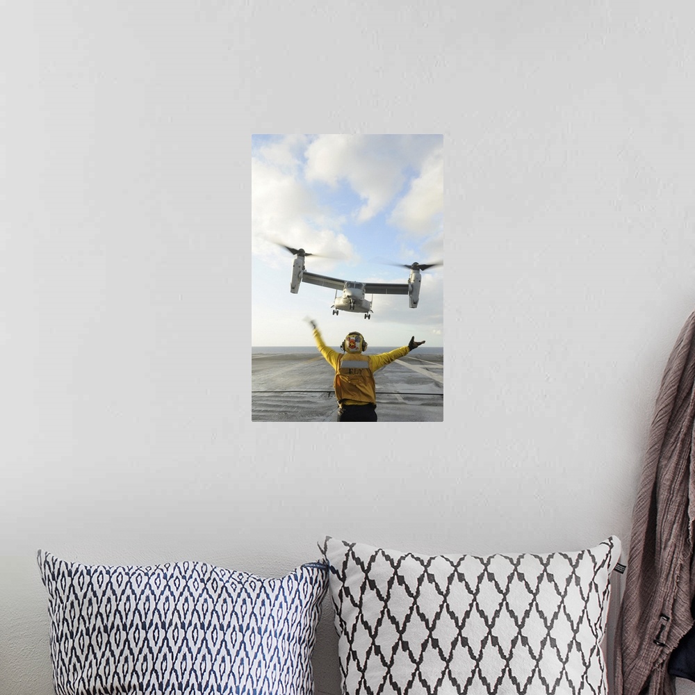 A bohemian room featuring Atlantic Ocean, February 5, 2012 - Aviation Boatswain's Mate signals an MV-22 Osprey to land on t...