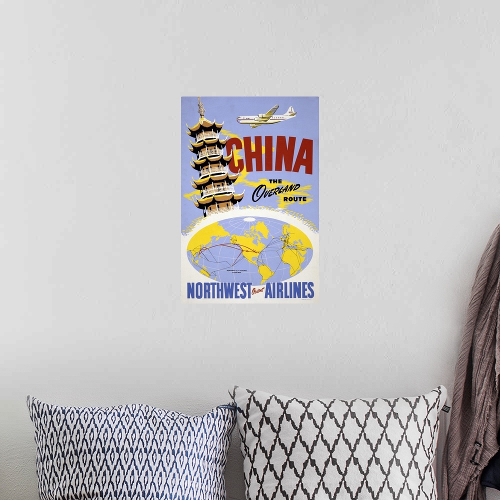 A bohemian room featuring Vintage travel poster of a pagoda and an airplane, above a Northwest Orient Airlines system map, ...