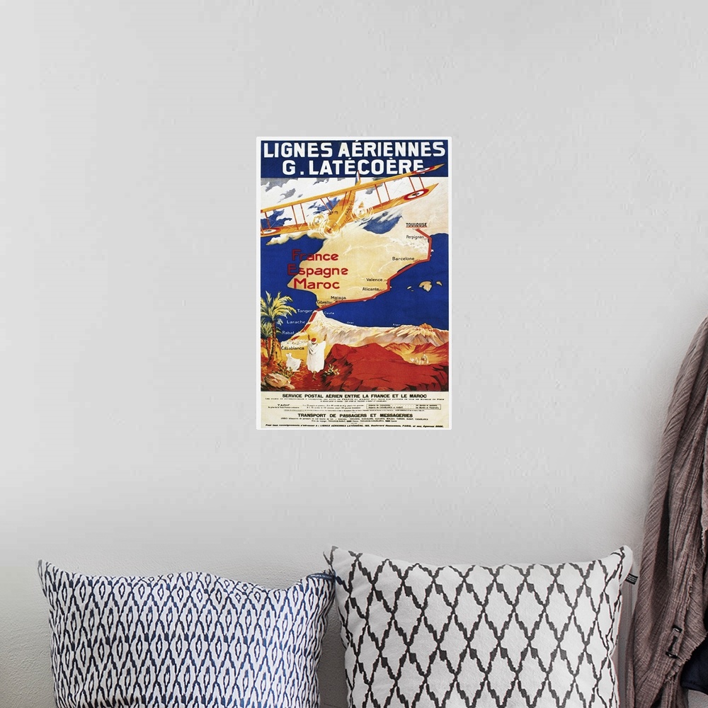 A bohemian room featuring A poster for the French airline Lat?co?re, promoting its air mail and passenger service to Spain ...
