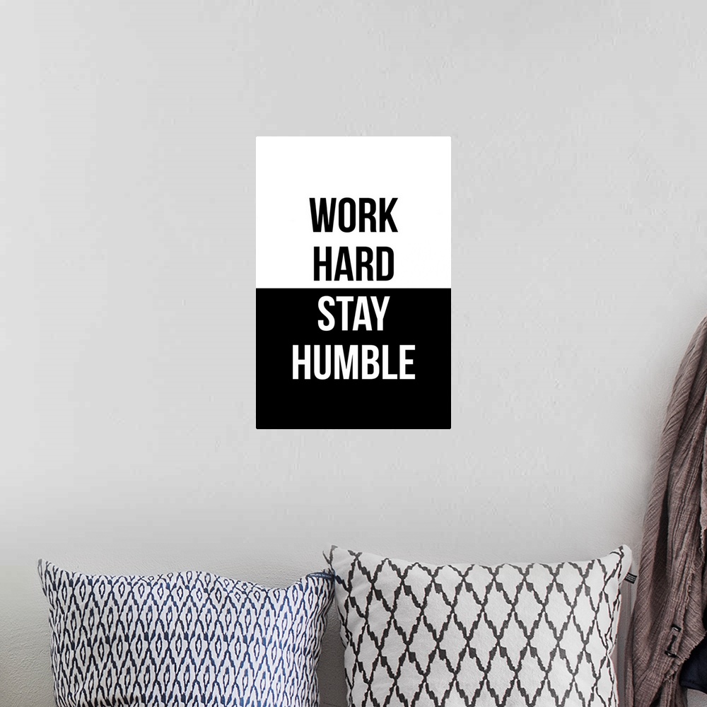 A bohemian room featuring "Work Hard, Stay Humble" in black and white.