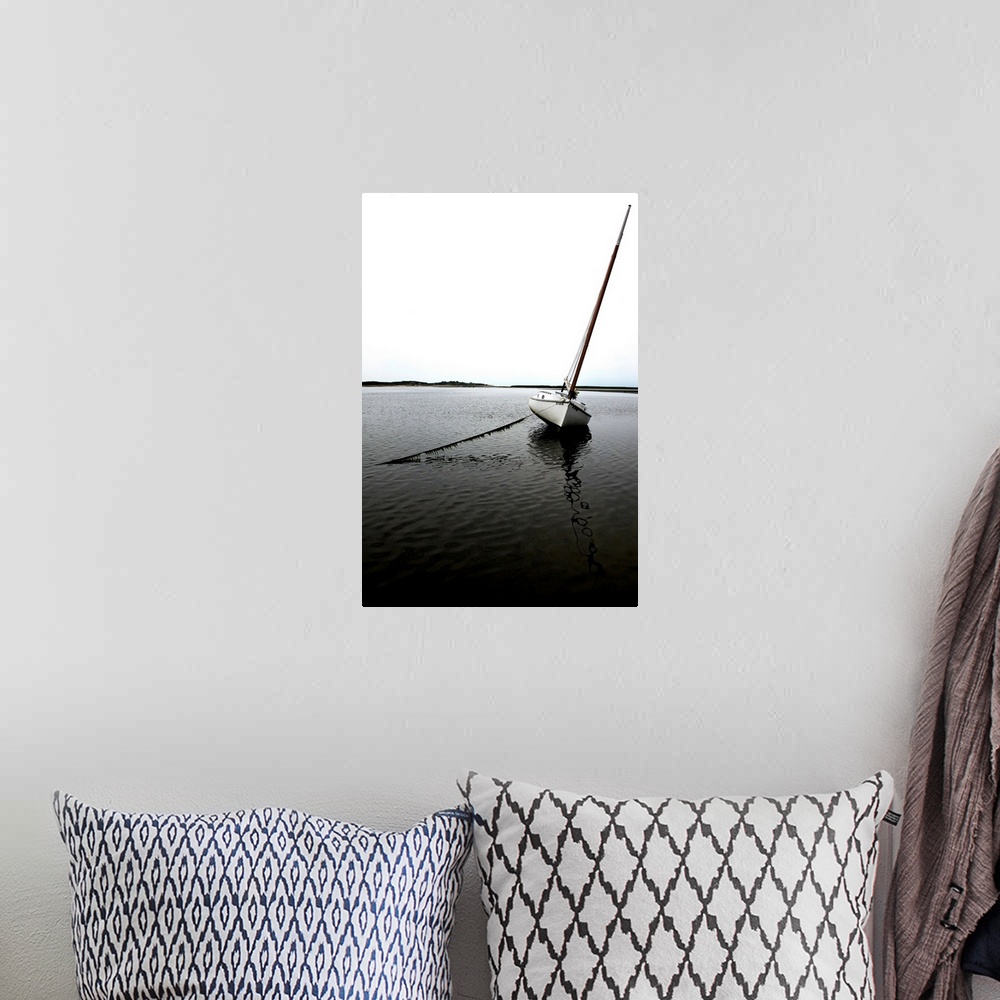 A bohemian room featuring Photograph of an anchored sailboat in calm waters.
