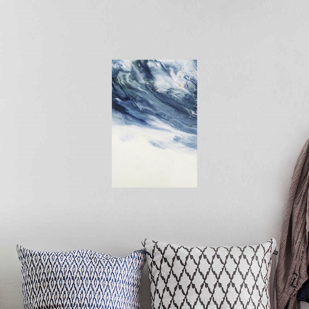 A bohemian room featuring Large abstract art with deep shades of blue marbling with white at the top and a solid white bottom.
