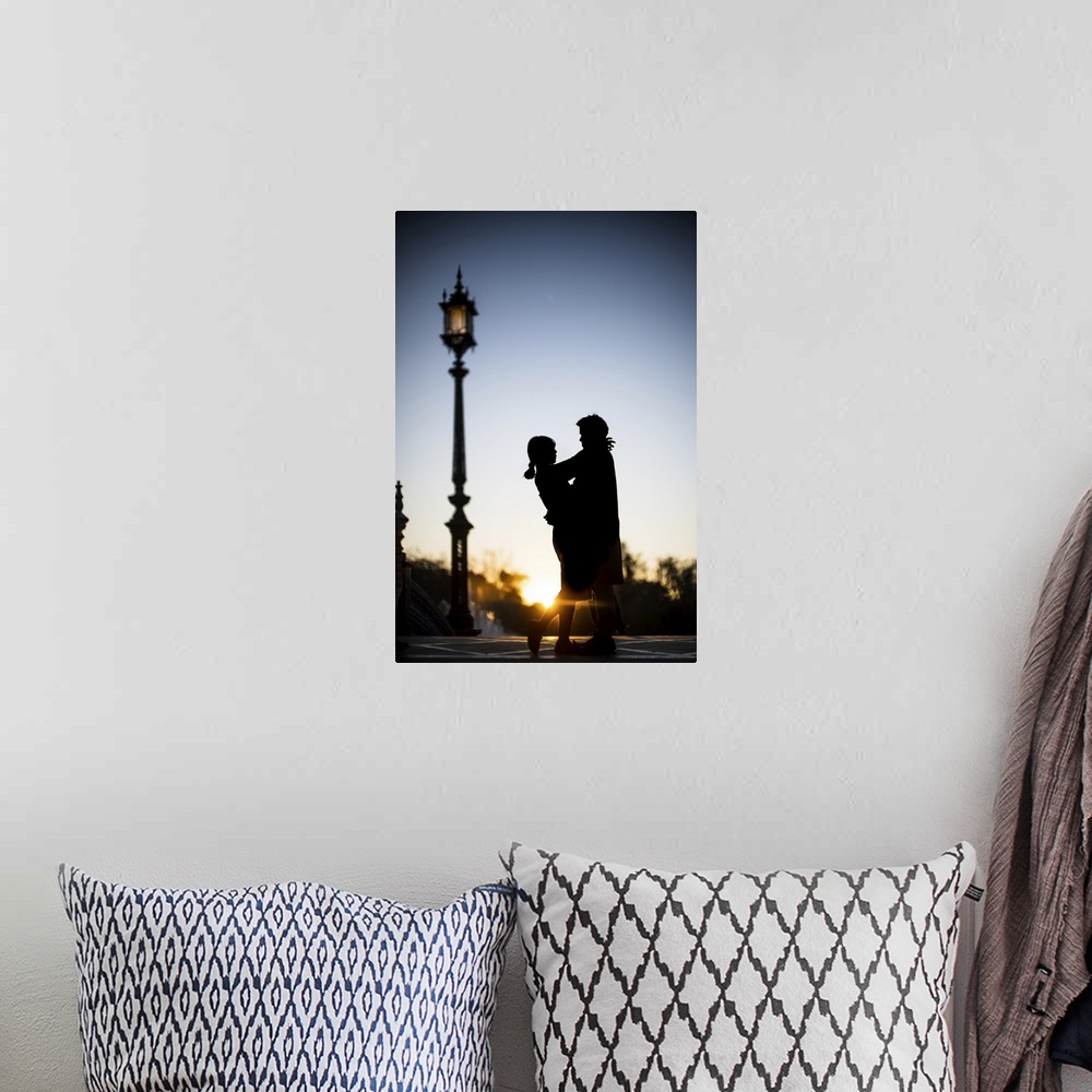 A bohemian room featuring Young couple embracing at sunset, Plaza de Espana, Seville, Spain.
