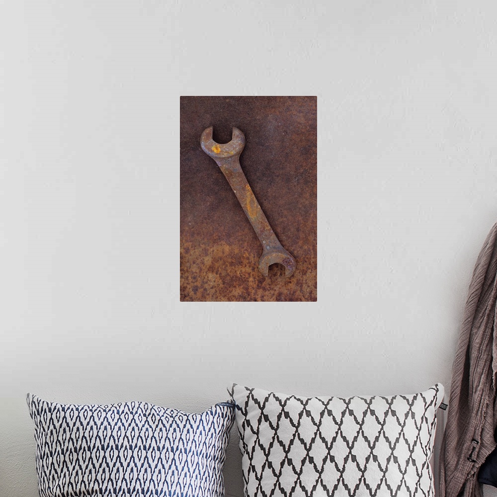 A bohemian room featuring Heavy double-headed spanner lying on rusty metal sheet