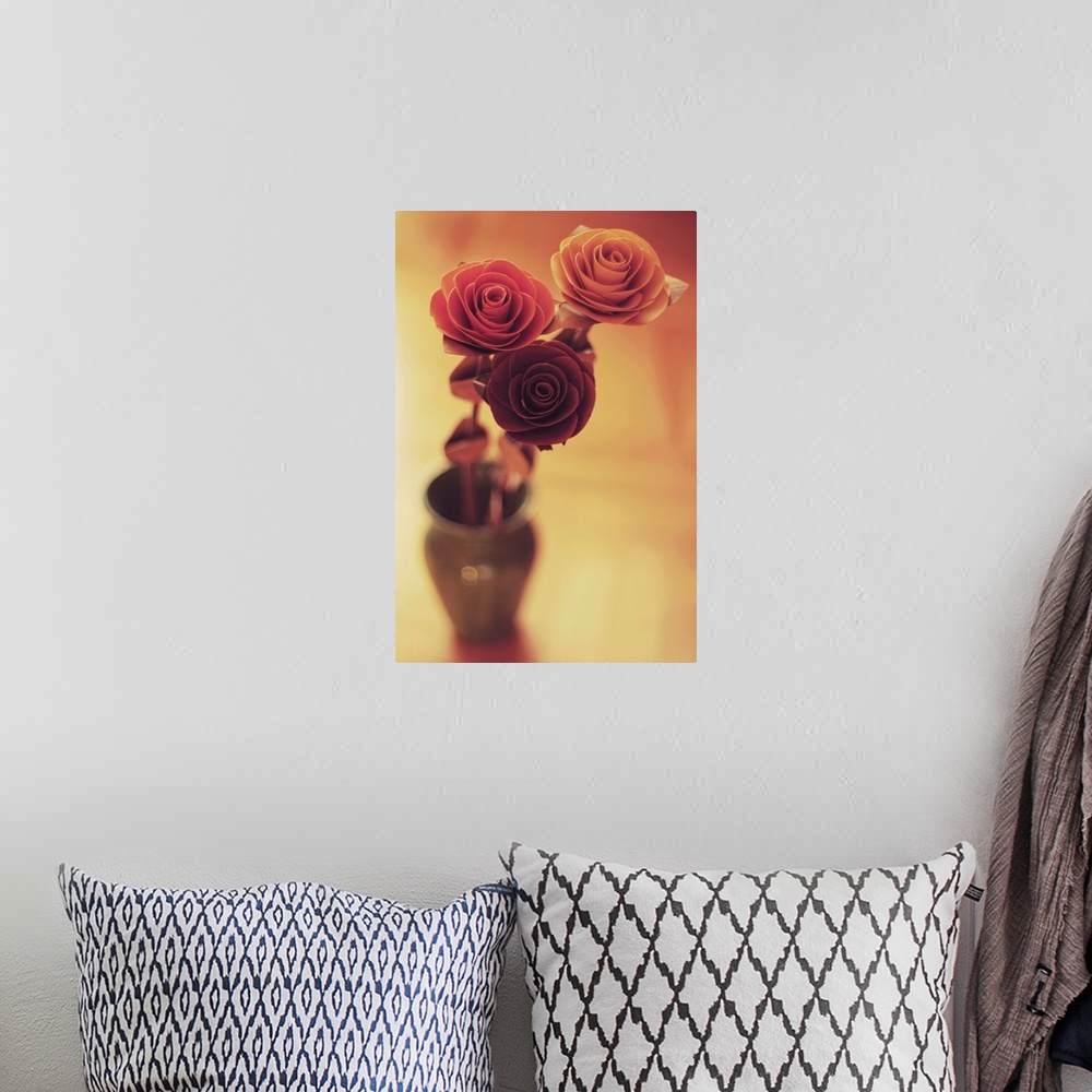A bohemian room featuring Three colourful roses in a small vase