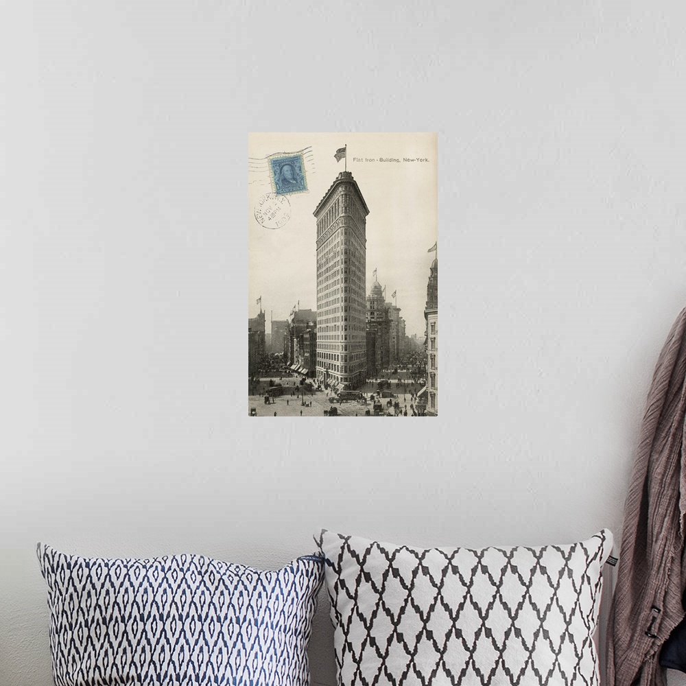 A bohemian room featuring Vintage photograph of the Flat Iron building with a blue stamp to the left of the image.