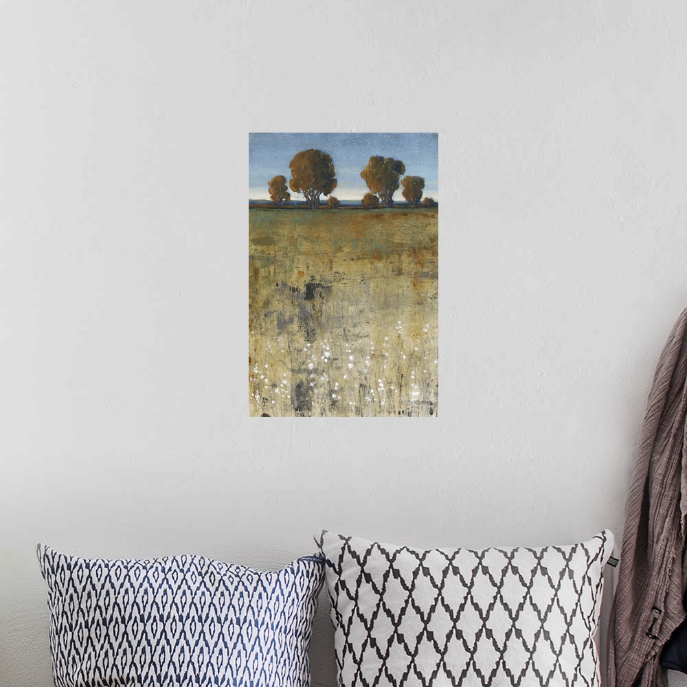 A bohemian room featuring Contemporary painting of a field with trees in the distance.
