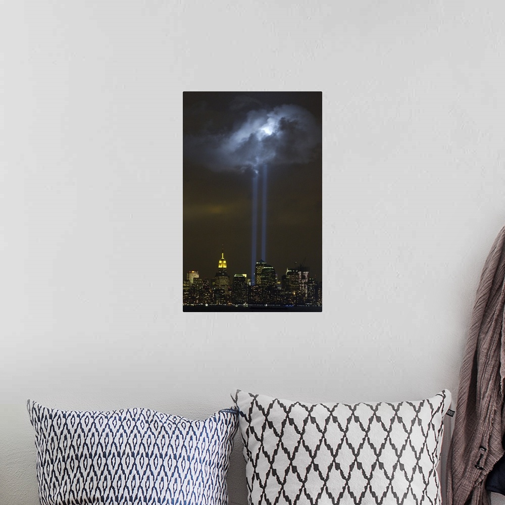 A bohemian room featuring Tribute in Light Memorial illuminates a passing cloud above lower Manhattan. Sept. 9, 2004. The t...