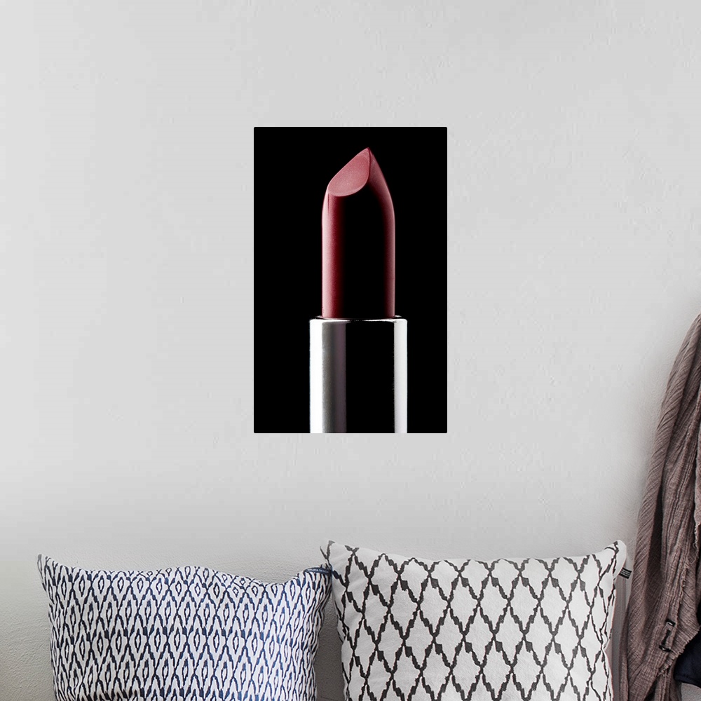 A bohemian room featuring Red lipstick against black background, close-up