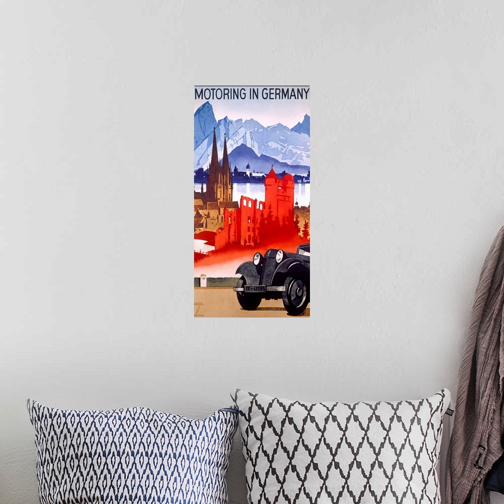 A bohemian room featuring Vintage car advertisement poster for German cars with the front of a car parked on the road and f...