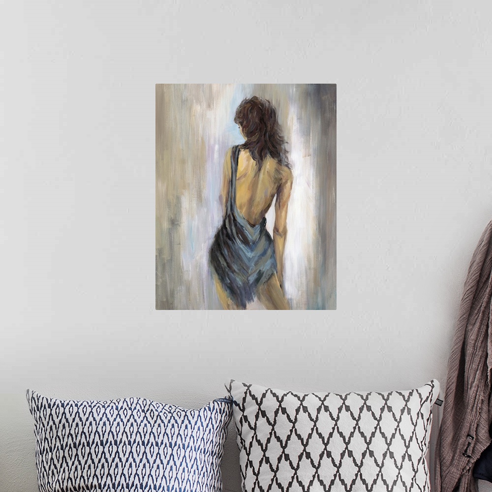 A bohemian room featuring Home decor artwork of a rear view of a woman wearing a blue backless dress.