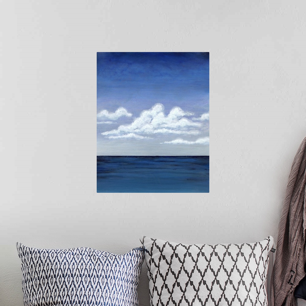 A bohemian room featuring Contemporary decor art of a seascape under puffy clouds.