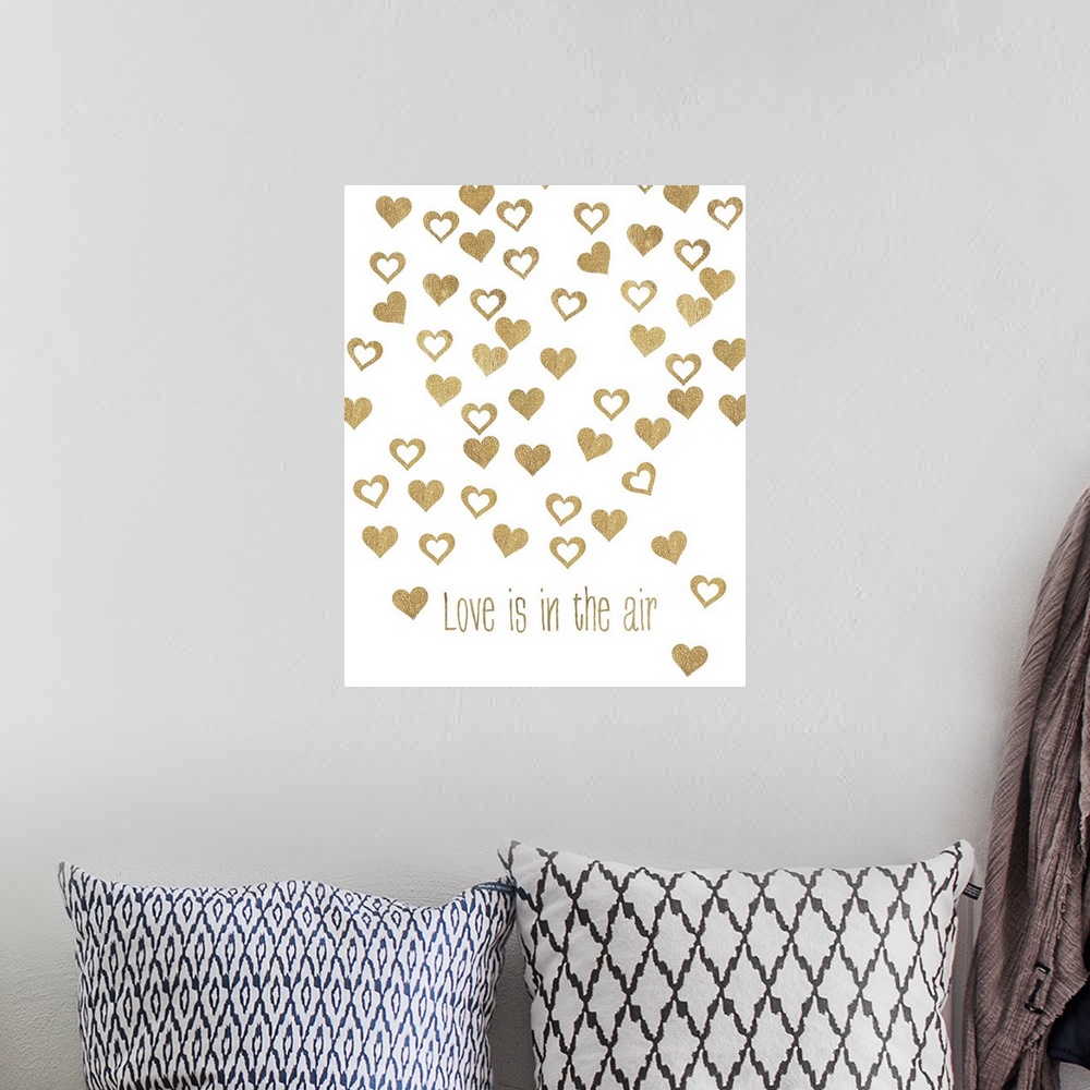 A bohemian room featuring Gold lettering and floating heart shapes against a white background.